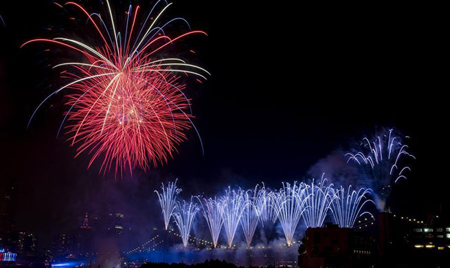 People watch fireworks exploding during U.S. Independence Day celebration