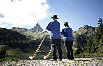 Participants take part in Alphorn meeting at Seebenalp, Switzerland